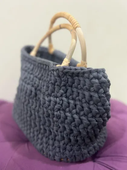 A side view of the grey T-shirt yarn bag, highlighting the texture of the chunky stitches.
