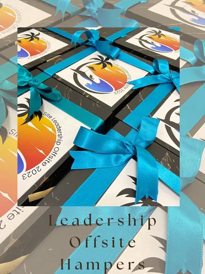 Custom-branded gift boxes for a corporate leadership offsite event in 2023. The vibrant branding and neat packaging reflect a professional and thoughtful gesture.