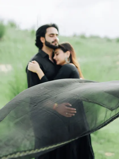 An artistic and emotional portrait, with a black dupatta flowing in the wind, adding a touch of mystery and grace.