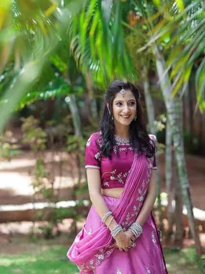 A happy, candid shot of the bride-to-be at her engagement. Her natural-looking makeup and soft curls create a romantic and carefree style.