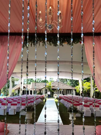 A view from inside the mandap, looking out at the guest seating. The delicate crystal hangings add a touch of sparkle and elegance to the ceremony space.