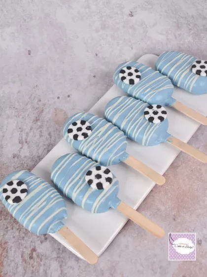Blue and white cakesicles decorated with soccer ball toppers. These are always a hit with kids and are easy to customize for any party color scheme.