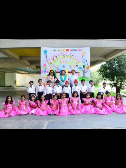 A class from Brigade School looking pretty in matching bright pink gowns, designed for a colorful and coordinated group performance.
