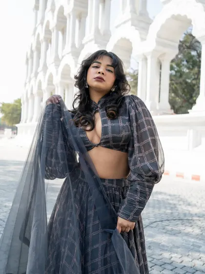 Who said wearing Indian can't be fun and playful? This grey printed Indo-western lehenga is fashion-forward.