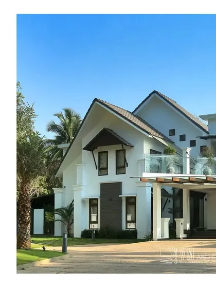 The Mannath House features a striking contemporary design with gabled roofs and a clean white finish, creating a bold architectural statement.