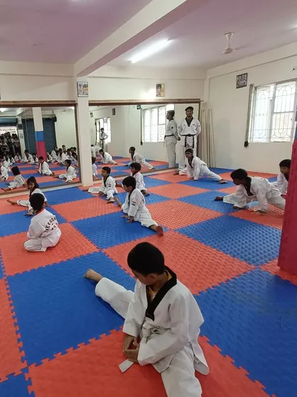 Students hold their splits, building both physical and mental endurance.