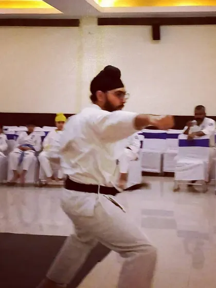 Senpai Harjas, a 1st Dan Black Belt, performs a powerful punch during a kata demonstration at our Kagami Biraki ceremony.