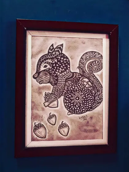 A playful squirrel, its body and tail decorated with various mandala and zentangle designs.