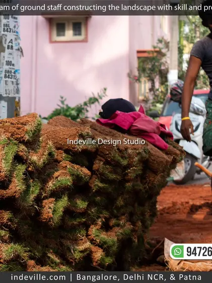 A worker carrying rolls of natural grass sod, ready for installation. I use high-quality materials to create instant, beautiful lawns for my clients.