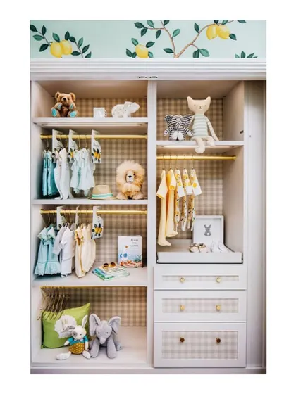 I believe the inside of a wardrobe should be just as fun as the outside. Here, I used a cheerful gingham pattern and yellow hanging rods to make this custom closet a happy space.