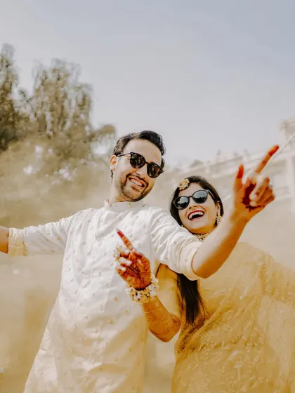The Haldi ceremony is all about pure, unadulterated fun. I love capturing the playful energy, like this candid shot of a couple sharing a laugh, sunglasses on, fully embracing the joyful chaos of the moment. This is what I mean by capturing *masti bhare pal*.