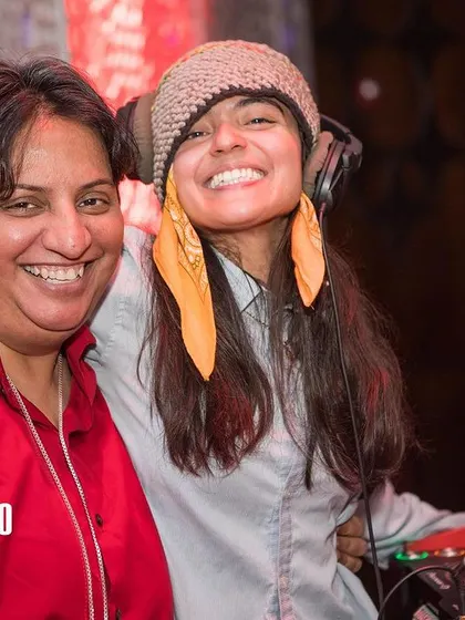 Sharing the decks with a fellow DJ at Bollywood Disco. I love collaborating with other artists to keep the music fresh and exciting all night long.