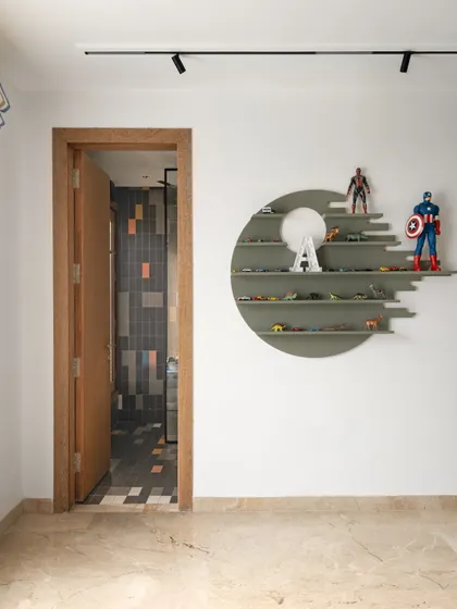 A unique circular shelving unit designed to display a collection of superhero and character toys. This element adds a personal and playful touch to the room while keeping it tidy.