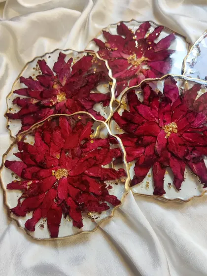 Another look at the beautiful floral resin coasters. The combination of deep red flowers, gold leaf, and a pearlescent background creates a look of pure luxury.