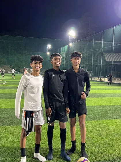 Three of our older players after a night training session. We provide opportunities for players to train under the lights, preparing them for matches in all conditions.