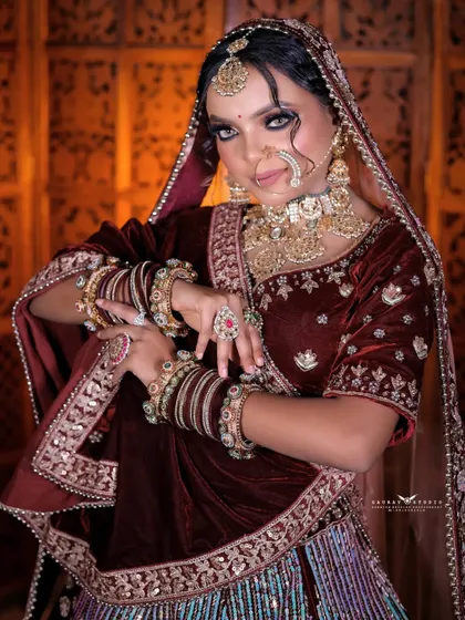 A playful and dynamic pose that showcases the bride's personality. The movement adds life to the photo, highlighting the flow of her heavy lehenga.