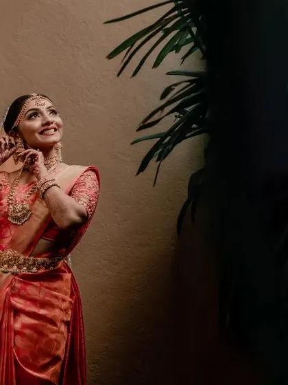 A candid moment of the bride getting ready, her face full of happy anticipation. We capture these behind-the-scenes shots that add depth to the wedding story.