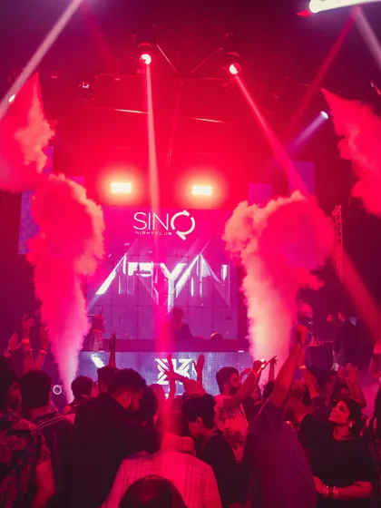 Full production mode at Sinq Nightclub, Goa. Smoke cannons, intense red lighting, and a packed floor. This is the high-octane clubbing experience I deliver.