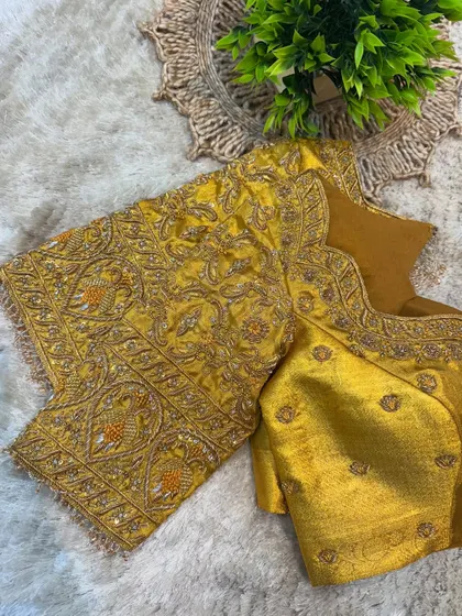 A complete view of the mustard yellow blouse, a perfect choice for a bride's Muhurtham ceremony.