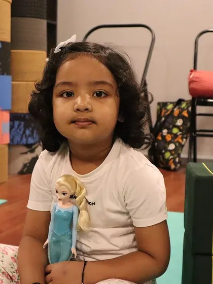 Even her doll gets to come to yoga class. It's a space where kids can be themselves and share what's important to them.