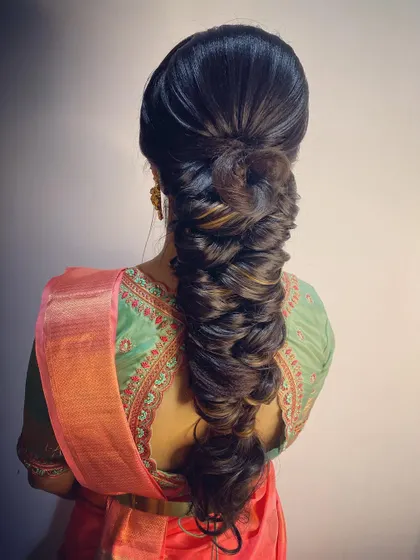 A voluminous, multi-strand braid that creates incredible texture and thickness. This is a statement braid, perfect for a bride who wants a dramatic and impressive hairstyle.