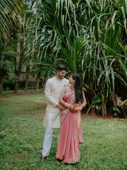 A classic, full-length portrait of the engaged couple in a beautiful park.