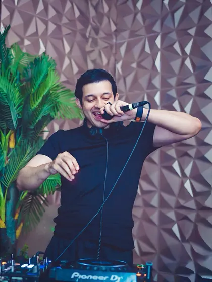 Getting interactive with the crowd, mic in hand. This is a typical moment from my sets where I engage directly with the audience to keep the energy flowing.