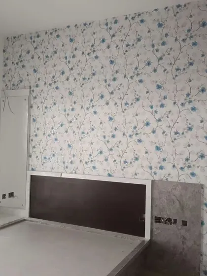 A similar cherry blossom pattern in blue, creating a cool and calming atmosphere in this bedroom.