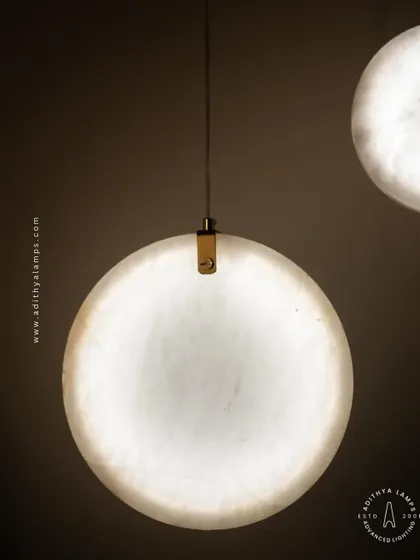 Showcasing our disc-shaped marble pendants. The light emanates softly through the thin slice of natural marble, revealing its unique veining. These fixtures are available in different shapes and look stunning hung in pairs or trios.