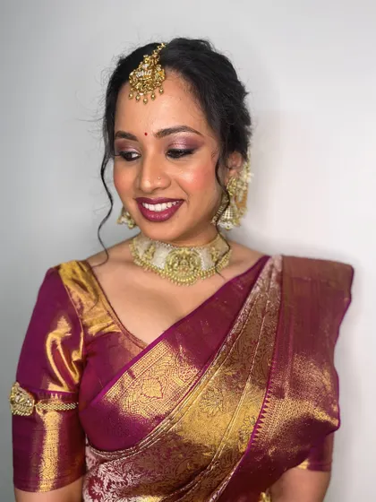 A close-up on the soft, shimmery eye makeup and bold lip. This combination is perfect for a bride who wants a touch of modern glam with her traditional attire.
