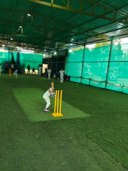A young player practices his batting stance indoors. These sessions are perfect for focusing on technical details without worrying about external weather conditions.