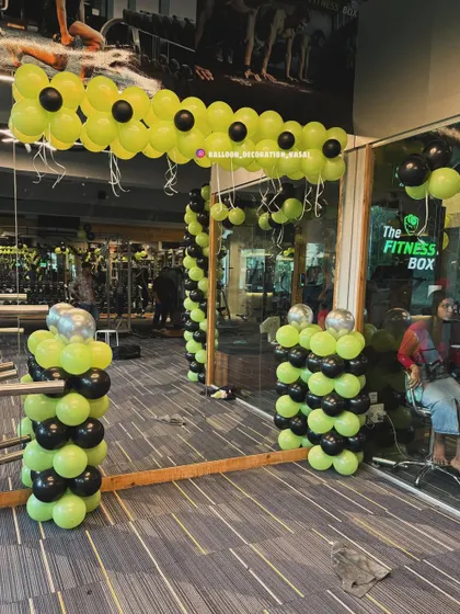This image shows the interior view of the gym decoration. I placed balloon pillars and simple garlands inside to carry the theme throughout the space, ensuring the festive look is visible from all angles.