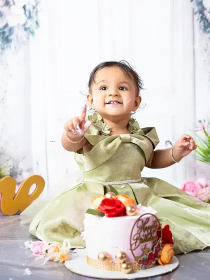 Celebrating turning one! This portrait captures the excitement and personality of a one-year-old during her custom-themed cake smash session.