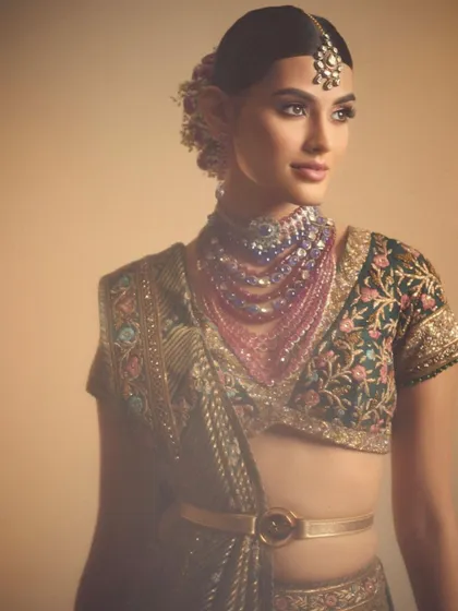 This look demonstrates the art of draping and styling with makeup. The soft, diffused eyeshadow and belted saree create a contemporary yet traditional aesthetic that many modern clients request.