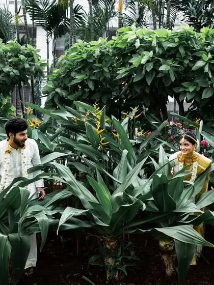 A playful shot of the couple peeking at each other through the leaves. This adds a fun and spontaneous element to their portrait session.