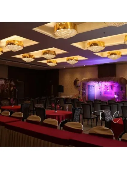 An overview of the event space, where modern elegance meets traditional charm. The main stage with the village theme stands as the focal point of the celebration hall.