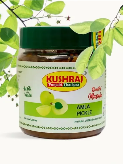 My Amla Pickle, presented with fresh amla leaves to emphasize its natural origins. It's a healthy choice, full of flavor.