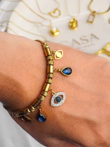 A detailed close-up of a charm bracelet, showcasing the fine craftsmanship and unique design elements. Macro photography like this is crucial for jewellery brands to highlight the quality and detail that customers look for.