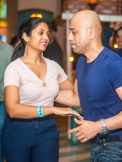 A focused and connected pair, moving as one. This is the beauty of partner dancing.