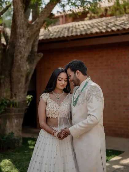 A stunning bride in a white lehenga, exuding grace and elegance. We use creative framing and lighting to capture a variety of beautiful portraits.