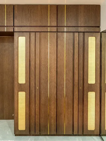 A detail of the wardrobe, made with a veneer finish, gold T-patti, and cane sandwiched between glass to enhance its nuance.