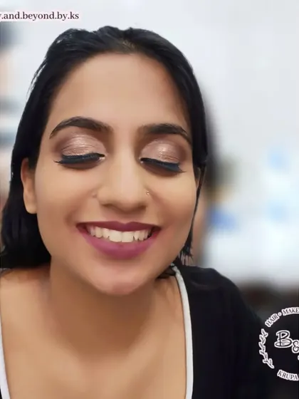 A happy client showing off her soft bridesmaid glam. The look features a dewy, glowing base, a soft brown smokey eye, and a bold lip color that perfectly complements her features.