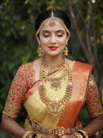 Another beautiful portrait of Taanya, showcasing the intricate temple jewelry that completes her bridal look.