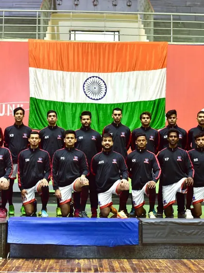 The Indian futsal team kneels for a photo in front of the national flag. We are honored to host national teams as they prepare for and compete in important events.
