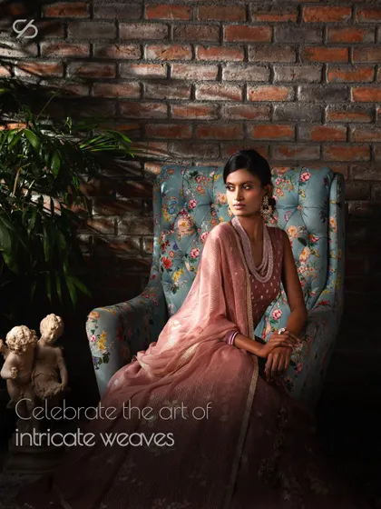 Exquisitely harmonizing with the wearer's essence, this dusty rose lehenga allows your true beauty to shine through. The model's seated pose shows the beautiful drape of the fabric.