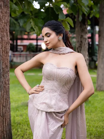 This outfit is perfectly balanced for a cocktail evening. I designed it with a hand-embroidered strapless corset top and a draped pant-sari, creating an effortlessly glamorous and modern silhouette.