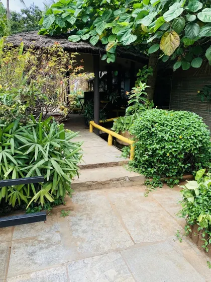 A stone path winds through dense, leafy bushes, leading to another hidden part of the resort. There is always a new corner to discover here.