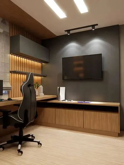 A sophisticated teen's gaming room with a dark color palette, wood accents, and a large desk for a multi-monitor setup.