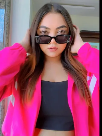 Embracing the rhythm of life with a pop of color in this bright pink jacket.