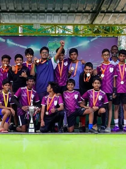 The U-15 Boys champions from Winmore Academy pose as a team after their tournament victory, showcasing the pride and unity of a winning squad.